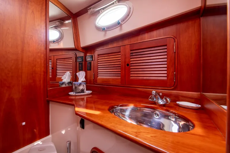 Chic Yacht Photos Pics Luxurious wooden interior of 2003 Hinckley Talaria 44 Express yacht bathroom.