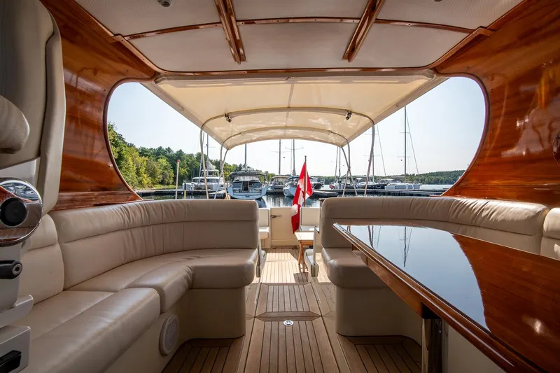 Chic Yacht Photos Pics Luxurious interior of 2003 Hinckley Talaria 44 Express yacht with elegant seating and wood finish.