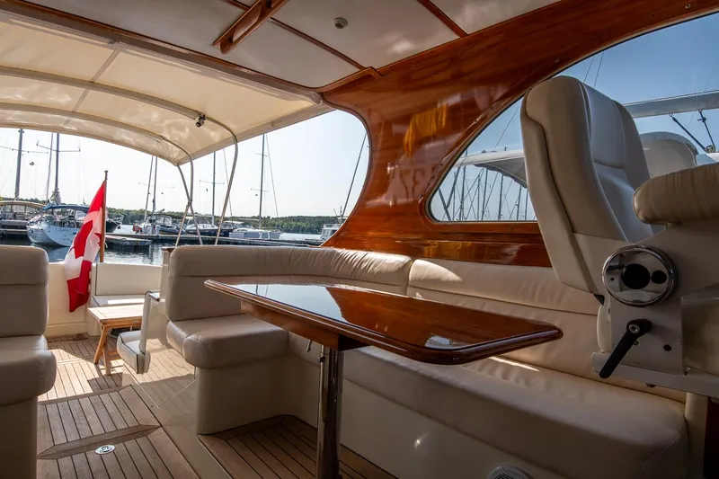 Chic Yacht Photos Pics 2003 Hinckley Talaria 44 Express yacht interior with elegant wood finish and seating.