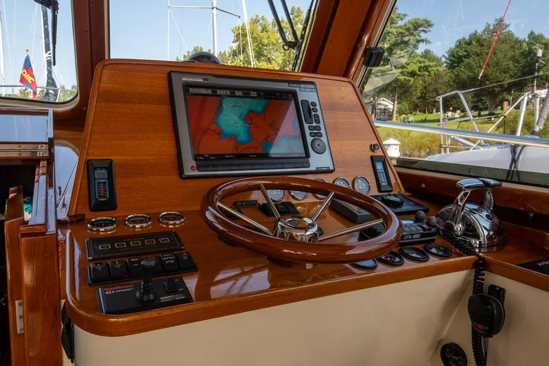 Chic Yacht Photos Pics 2003 Hinckley Talaria 44 Express helm with navigation system and wooden steering wheel.