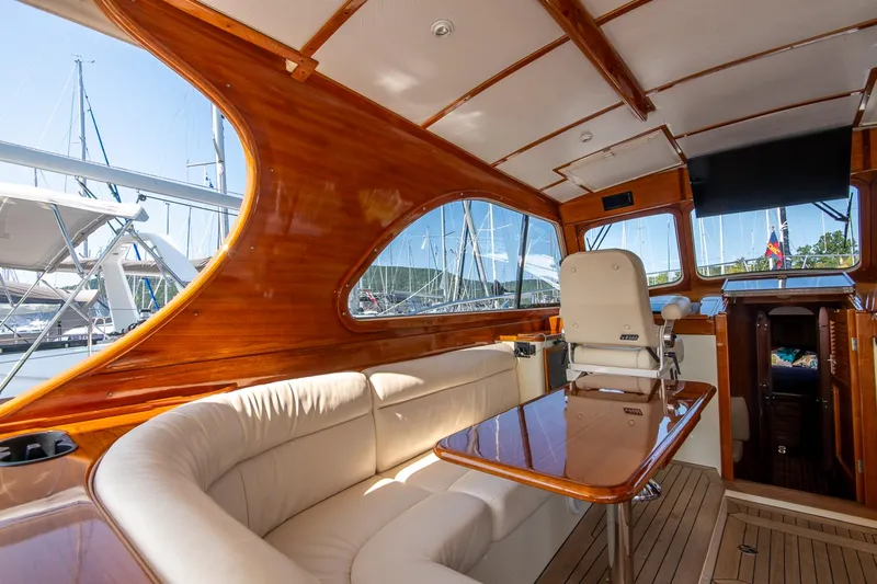 Chic Yacht Photos Pics Luxurious interior of 2003 Hinckley Talaria 44 Express yacht with wooden finish and plush seating.
