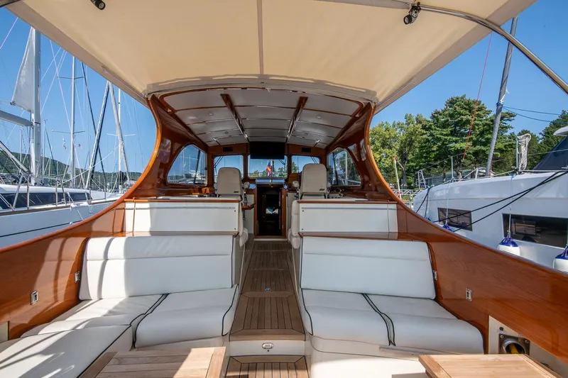 Chic Yacht Photos Pics 2003 Hinckley Talaria 44 Express yacht interior with white seating and wooden accents.