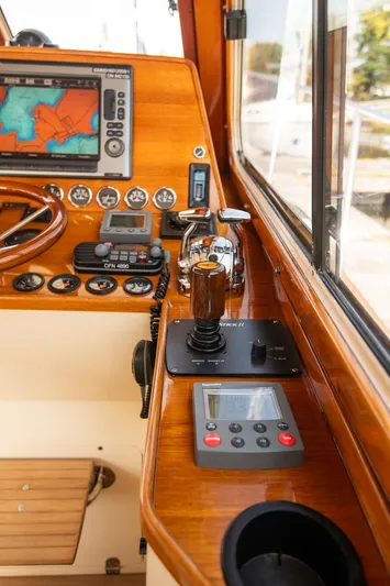 Chic Yacht Photos Pics 2003 Hinckley Talaria 44 Express helm with navigation controls and wooden dashboard.