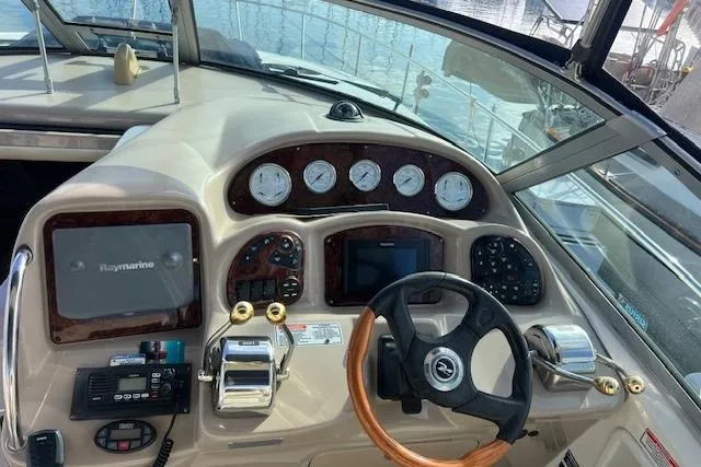 H20 Kiss Yacht Photos Pics 2005 Searay 320 boat dashboard with steering wheel and navigation instruments.