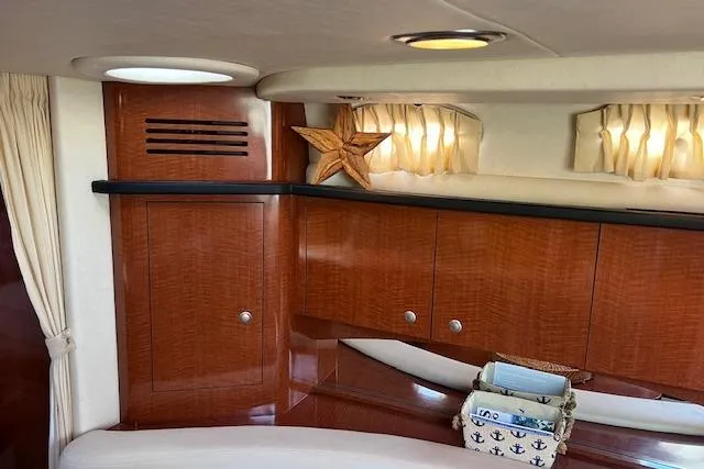 H20 Kiss Yacht Photos Pics 2005 Searay 320 yacht interior with polished wood cabinets and nautical decor.