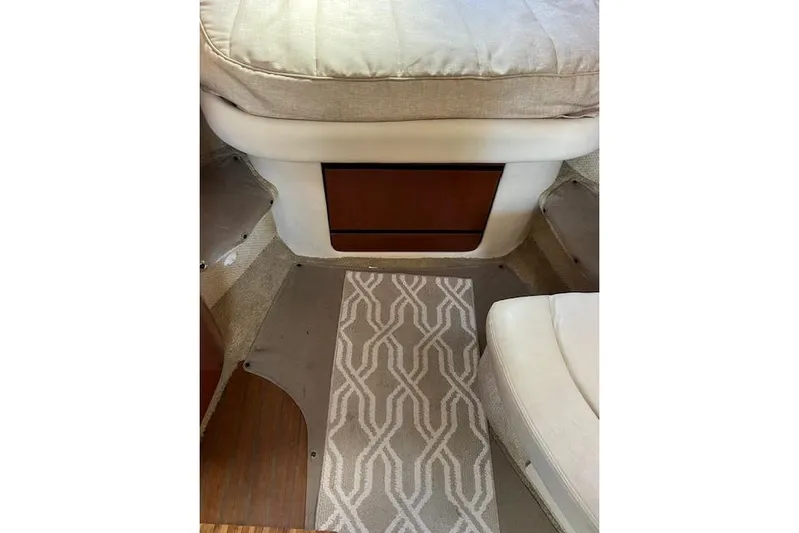 H20 Kiss Yacht Photos Pics Interior of a 2005 Searay 320 boat with patterned carpet and cushioned seating.