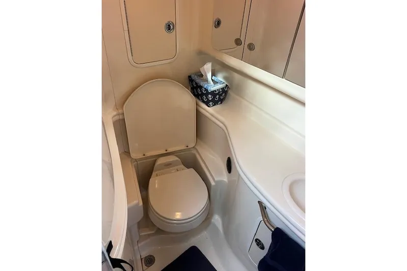 H20 Kiss Yacht Photos Pics 2005 Searay 320 boat bathroom with toilet, sink, and storage cabinets.