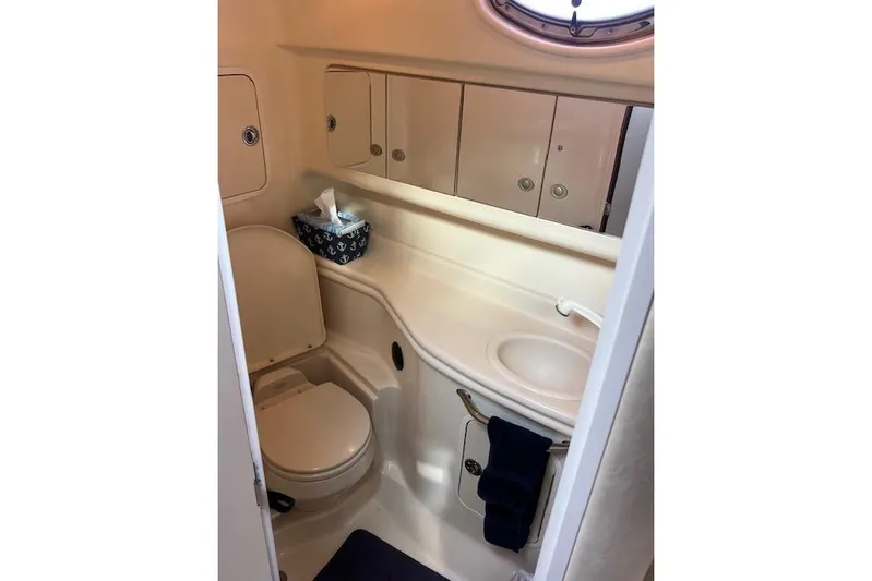 H20 Kiss Yacht Photos Pics 2005 Searay 320 boat bathroom with sink, toilet, and storage cabinets.