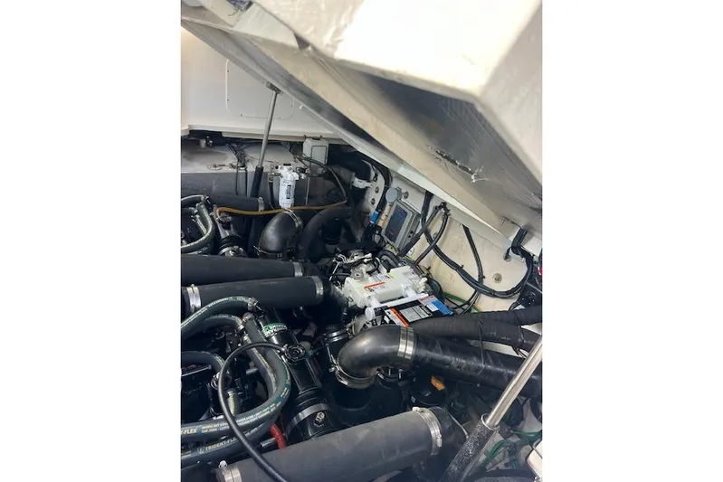 H20 Kiss Yacht Photos Pics Engine compartment of a 2005 Searay 320 boat, showcasing hoses and mechanical components.