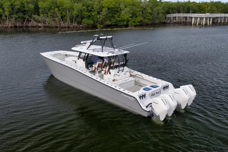  Yacht Photos Pics 2022 Freeman 42LR boat with triple Mercury engines on calm water.