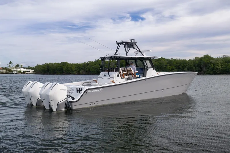  Yacht Photos Pics 2022 Freeman 42LR boat with four outboard engines on calm water.