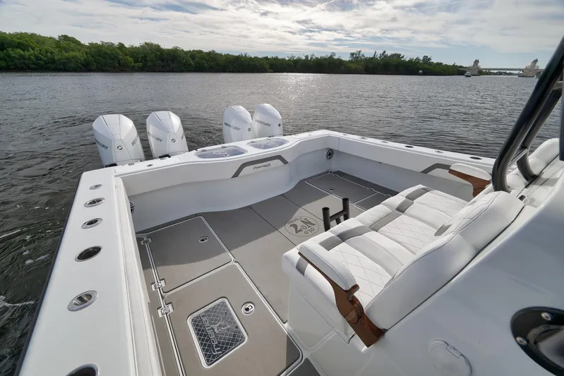  Yacht Photos Pics Luxurious 2022 Freeman 42LR boat with quad Mercury engines on a serene lake.