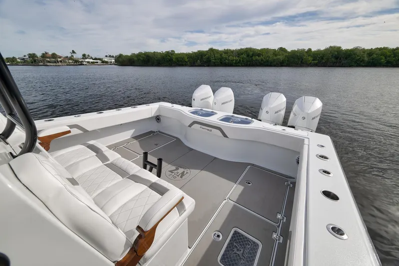  Yacht Photos Pics 2022 Freeman 42LR boat with luxurious seating and powerful Mercury engines on a calm waterway.