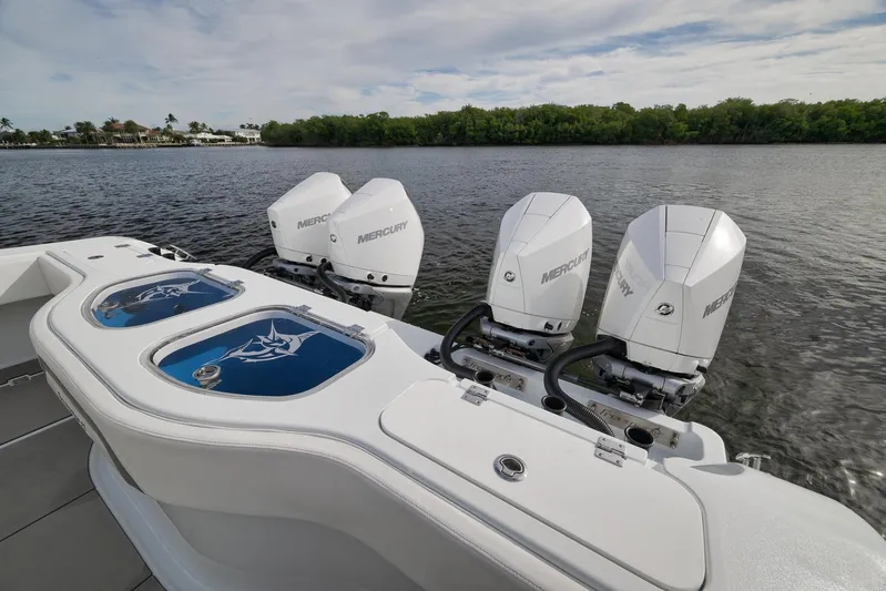  Yacht Photos Pics Freeman 42LR 2022 boat with four Mercury outboard engines on a calm lake.