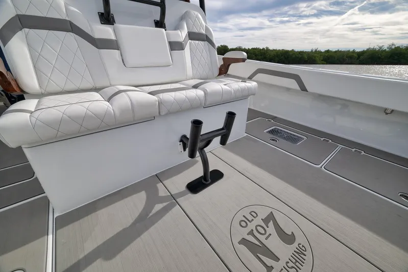  Yacht Photos Pics Luxurious seating on 2022 Freeman 42LR boat with custom flooring and rod holders.