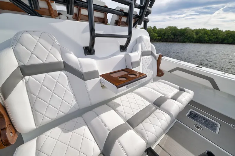  Yacht Photos Pics Luxurious seating on 2022 Freeman 42LR boat with quilted upholstery and cup holders.