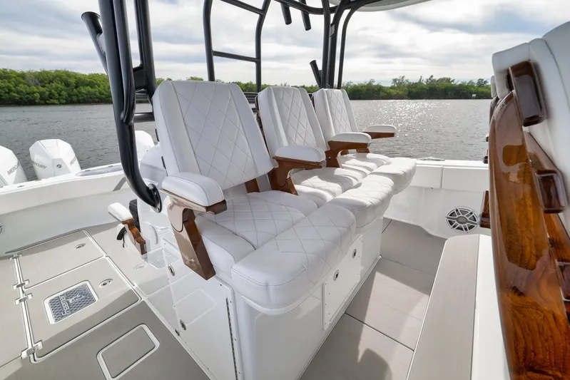  Yacht Photos Pics Luxurious seating on 2022 Freeman 42LR boat, featuring elegant white upholstery and wooden accents.