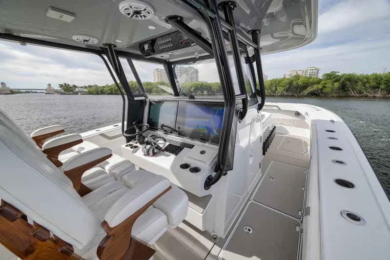  Yacht Photos Pics 2022 Freeman 42LR boat interior with modern helm, luxurious seating, and scenic waterway view.