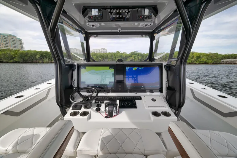  Yacht Photos Pics Cockpit of 2022 Freeman 42LR boat with advanced navigation displays and luxurious seating.
