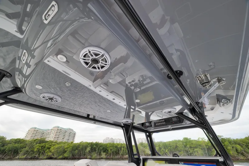  Yacht Photos Pics 2022 Freeman 42LR boat interior with speakers and control panel, overlooking waterfront buildings.