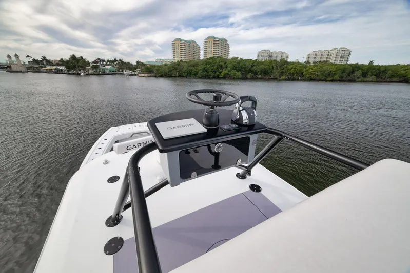  Yacht Photos Pics 2022 Freeman 42LR boat with Garmin navigation, docked near lush greenery and buildings.