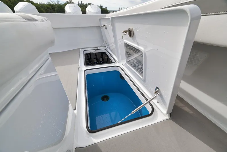  Yacht Photos Pics Open storage compartment on 2022 Freeman 42LR boat with blue interior.