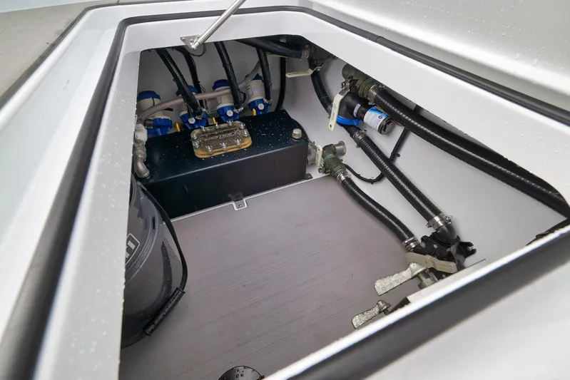  Yacht Photos Pics 2022 Freeman 42LR boat compartment with hoses and mechanical components.