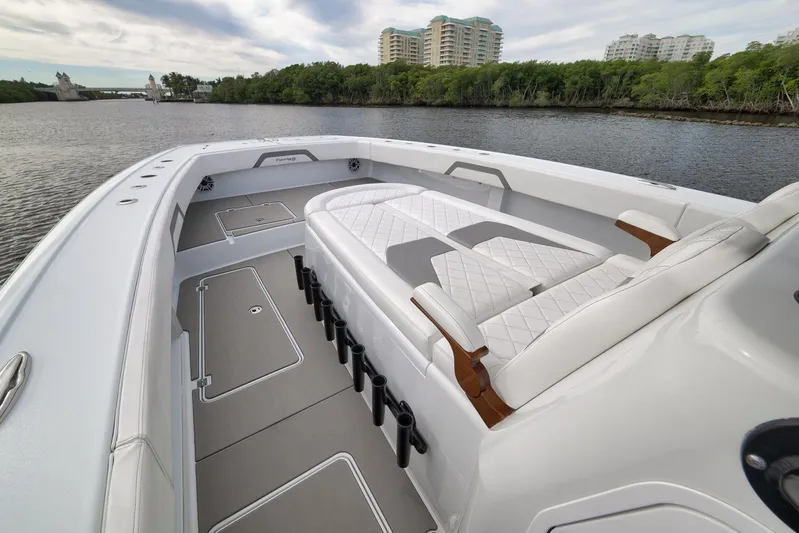  Yacht Photos Pics Luxurious 2022 Freeman 42LR boat interior with white seating, on a calm river.