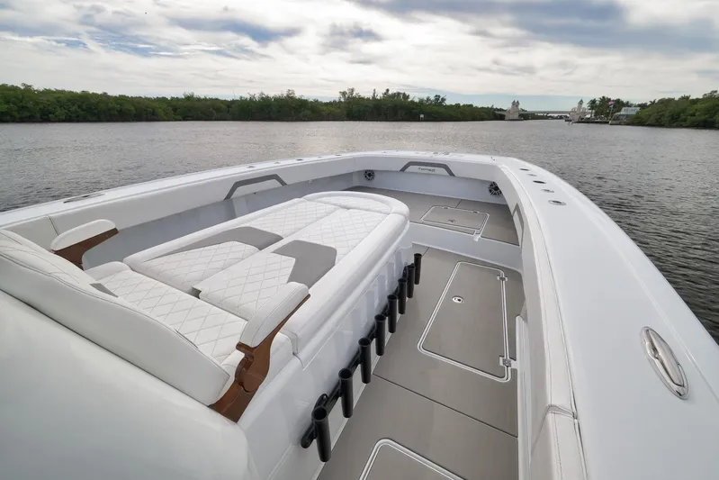  Yacht Photos Pics Luxurious 2022 Freeman 42LR boat interior with elegant seating on a serene waterway.