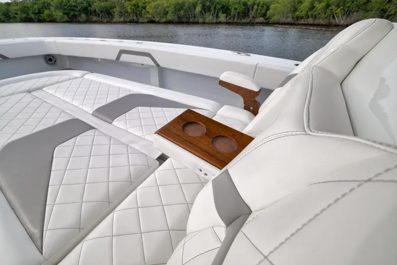  Yacht Photos Pics Luxurious seating on 2022 Freeman 42LR boat with quilted upholstery and wooden cup holders.