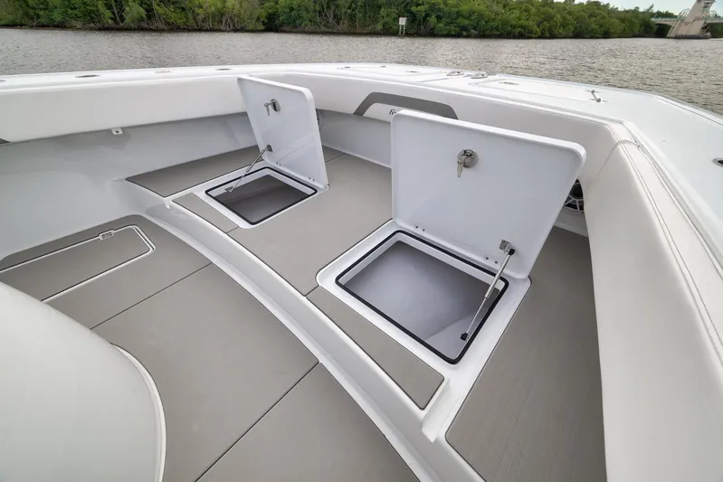  Yacht Photos Pics Freeman 42LR 2022 boat deck with open storage compartments, near water and greenery.