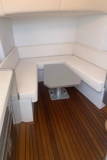  Yacht Photos Pics 2017 Maori 50 yacht interior with white seating and wooden flooring.