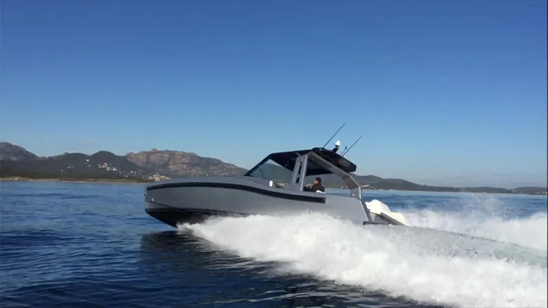  Yacht Photos Pics 2017 Maori 50 boat cruising on open water with mountains in the background.