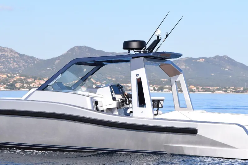  Yacht Photos Pics Modern 2017 Maori 50 boat cruising on calm waters with mountainous background.