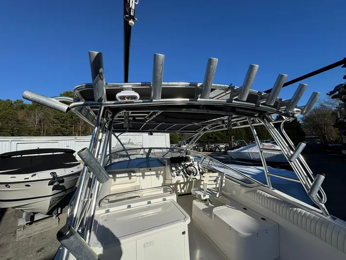  Yacht Photos Pics 2008 Fountain 38 Sportfish Express Cruiser with rod holders and helm, docked outdoors.