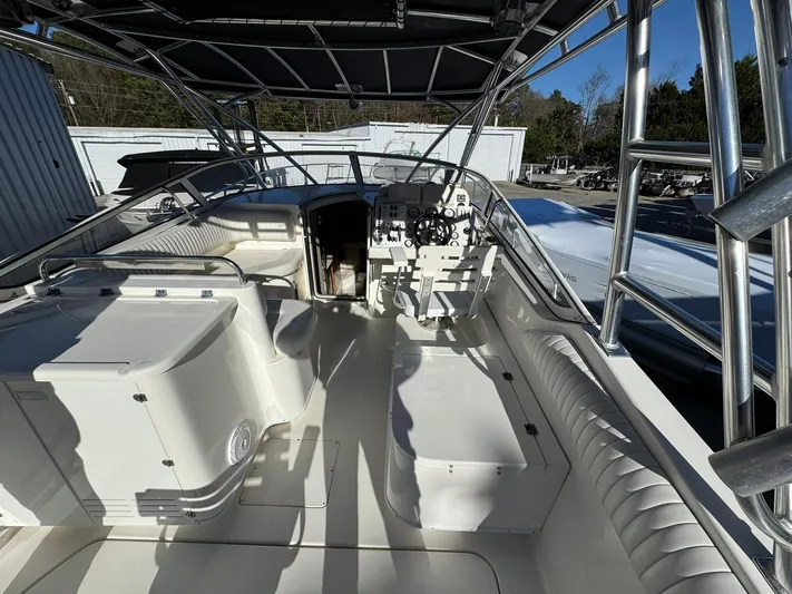  Yacht Photos Pics 2008 Fountain 38 Sportfish Express Cruiser interior with seating and helm, under a canopy.