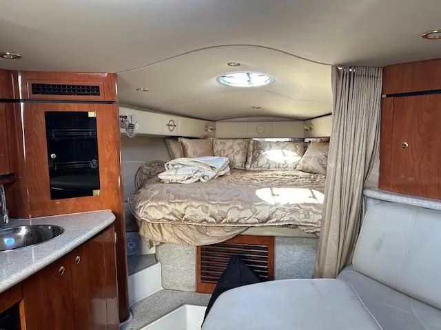 Yacht Photos Pics Interior of 2008 Fountain 38 Sportfish Express Cruiser with cozy bed and wood cabinetry.