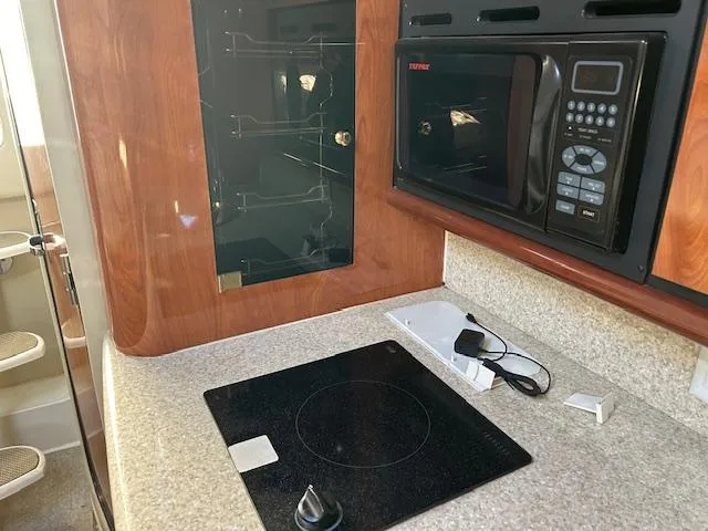  Yacht Photos Pics 2008 Fountain 38 Sportfish Express Cruiser kitchen with microwave and stovetop.