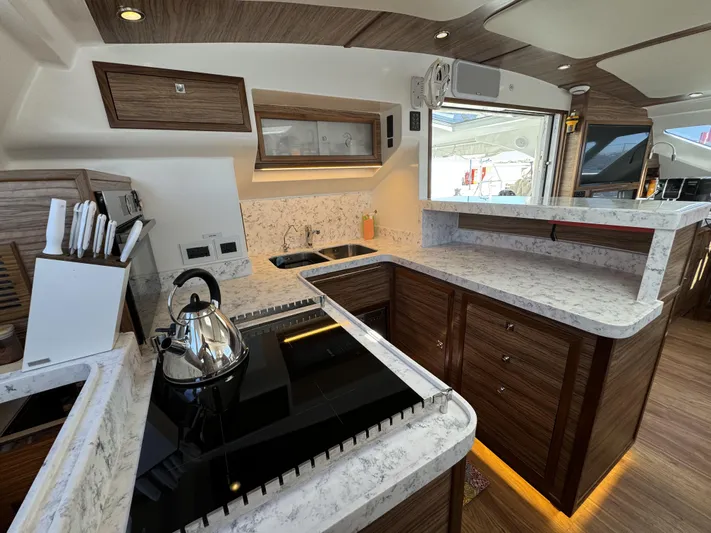 Alora Yacht Photos Pics Luxurious 2023 Knysna 500 SE yacht kitchen with modern appliances and elegant wood finishes.