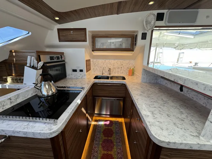 Alora Yacht Photos Pics Modern kitchen in 2023 Knysna 500 SE yacht with marble countertops and stainless steel appliances.