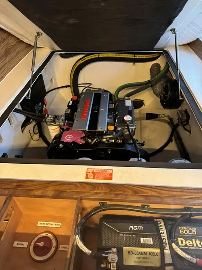 Alora Yacht Photos Pics 2023 Knysna 500 SE engine compartment with Yanmar engine and AGM battery setup.