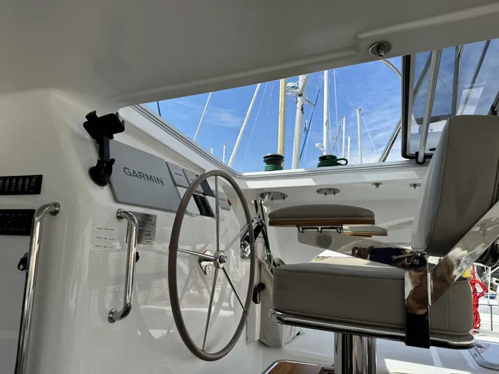 Alora Yacht Photos Pics Interior view of 2023 Knysna 500 SE yacht cockpit with steering wheel and Garmin equipment.