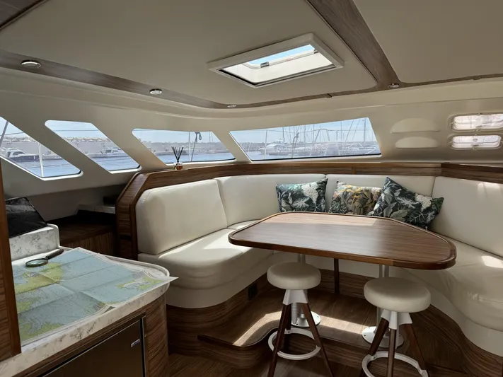 Alora Yacht Photos Pics Luxurious interior of 2023 Knysna 500 SE yacht with elegant seating and panoramic windows.