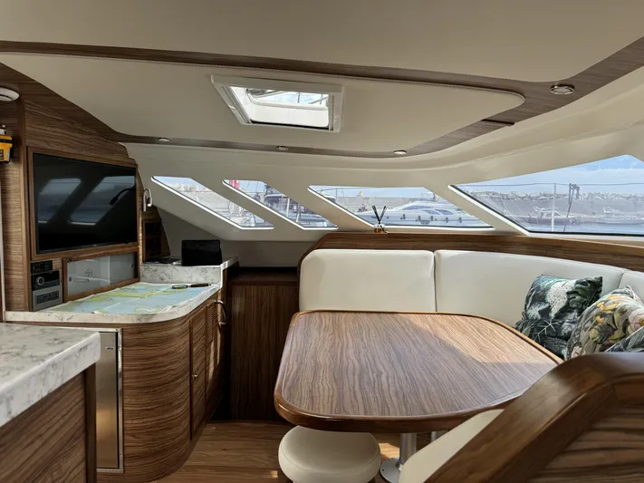 Alora Yacht Photos Pics Luxurious interior of 2023 Knysna 500 SE yacht with wood finish and seating area.