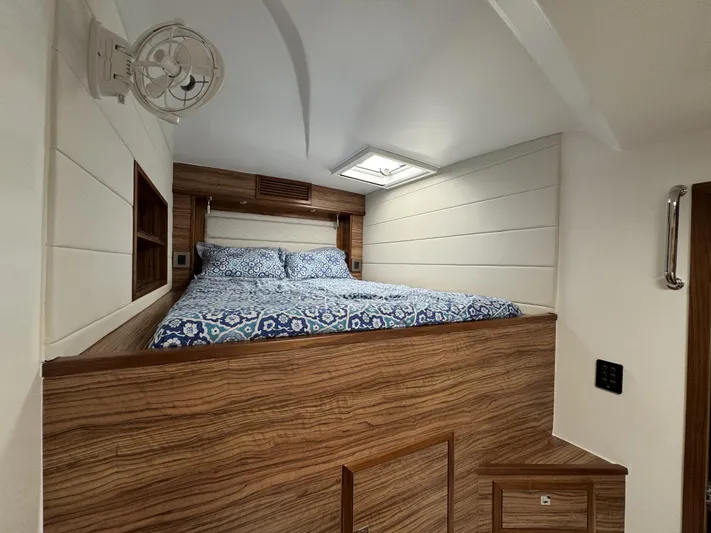 Alora Yacht Photos Pics Cozy bedroom in 2023 Knysna 500 SE yacht with patterned bedding and wood accents.