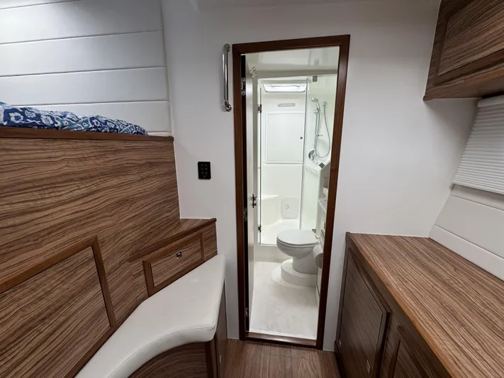 Alora Yacht Photos Pics 2023 Knysna 500 SE interior with wood finish and compact bathroom.