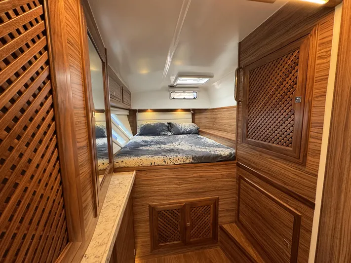Alora Yacht Photos Pics Luxurious 2023 Knysna 500 SE yacht cabin with elegant wood finish and cozy bedding.