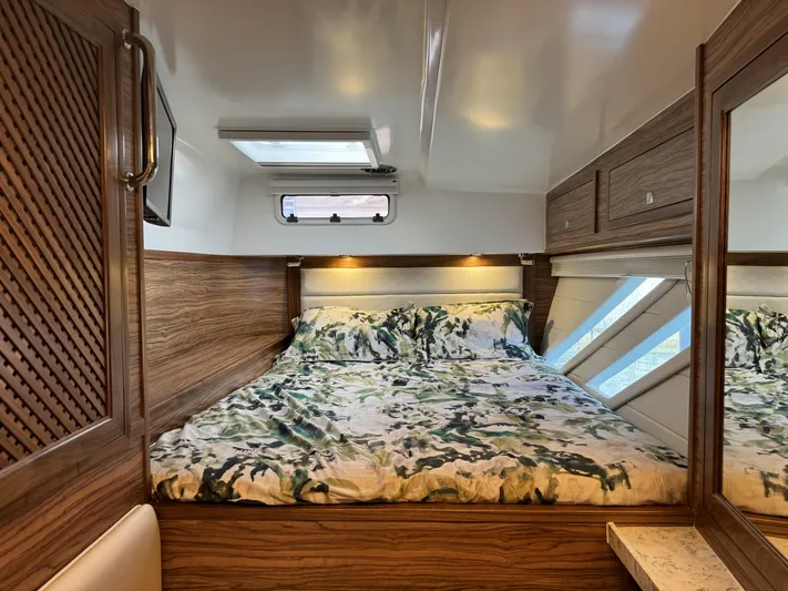 Alora Yacht Photos Pics Luxurious cabin interior of 2023 Knysna 500 SE with wood accents and cozy bedding.
