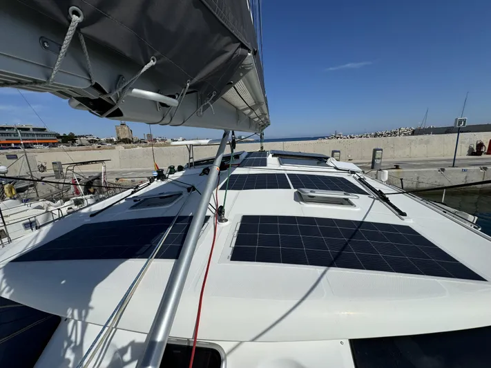 Alora Yacht Photos Pics 2023 Knysna 500 SE yacht with solar panels docked at a marina.