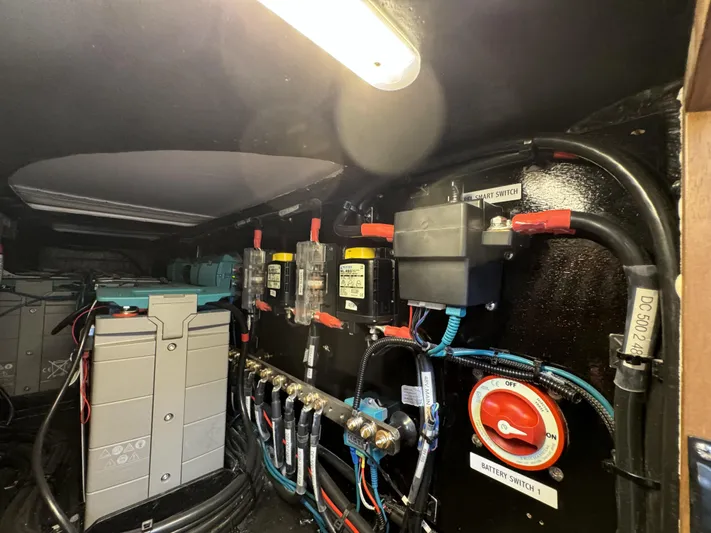 Alora Yacht Photos Pics Electrical system inside a 2023 Knysna 500 SE yacht, featuring battery switches and wiring.
